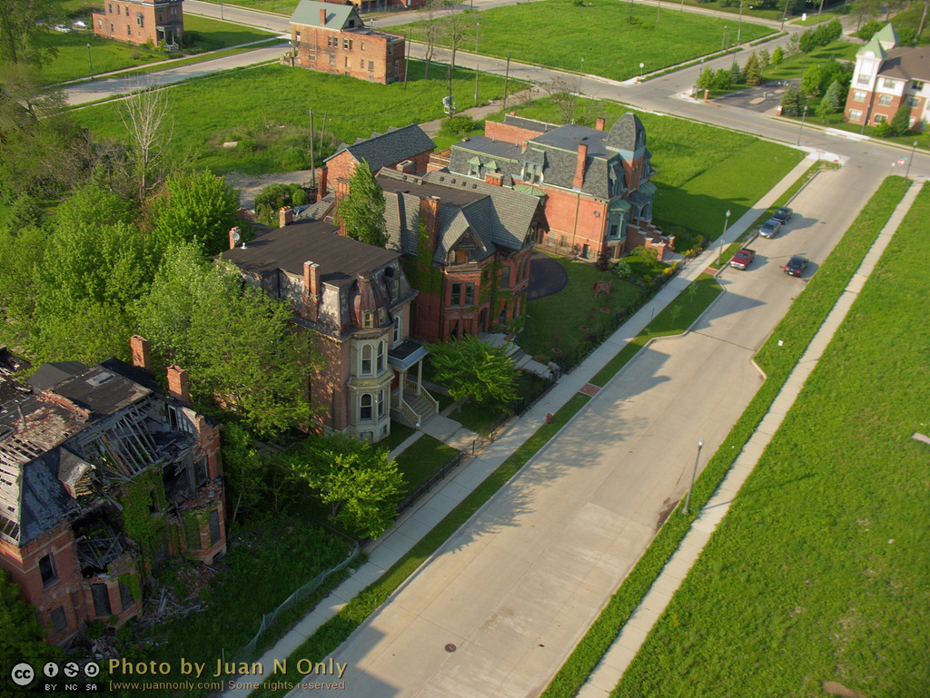 A block in Brush Park that contains a few run down homes alongside wide open space